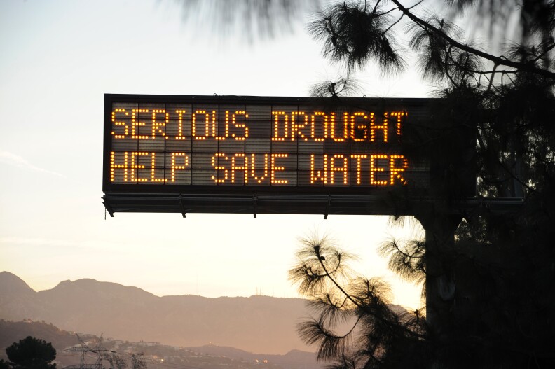 A sign over a highway in Glendale, California warns motorists to save water in response to the state's severe drought, February 14, 2014.  US President Barack Obama is visiting drought-stricken California today and is expected to announce more than $160 million in federal financial aid to help California recover from the crippling drought that is threatening the state's agriculture industry. AFP PHOTO / ROBYN BECK        (Photo credit should read ROBYN BECK/AFP/Getty Images)