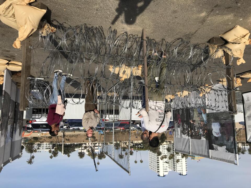 The barbed wire barricades are meant to represent what refugees have to deal with as they flee their home countries.