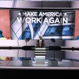 Dr. Ben Carson speaks on the second day of the Republican National Convention, as a portrait of Hilary Clinton, the presumptive Democratic party nominee for US president, appears on screens, at the Quicken Loans Arena in Cleveland on July 19, 2016.