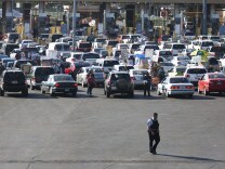 A member of the US Border Patrol walks behind the line of cars at the San Ysidro gate at the border between Mexico and United State in Tijuana, Mexico on May 04, 2011, after  the US military operation that ended in the killing of Al-Qaeda's mastermind, Osama Bin Laden. Though Mexico's government has not announced special security measures after the US commando raid in Pakistan claimed the life of the world's most wanted man, there was close cooperation with US authorities to check for potentially dangerous persons.   AFP PHOTO / FRANCISCO VEGA (Photo credit should read FRANCISCO VEGA/AFP/Getty Images)
