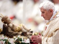 Pope Benedict XVI walks in front a manger as he attends the Christmas night mass at the St. Peter's Basilica on Dec. 24, 2012 in Vatican City, Vatican.