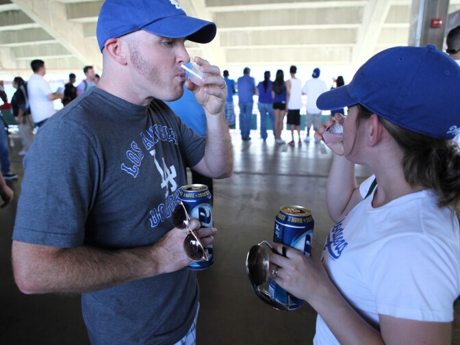 Dodgers fans sample a Soju cocktail at a game on June 28.