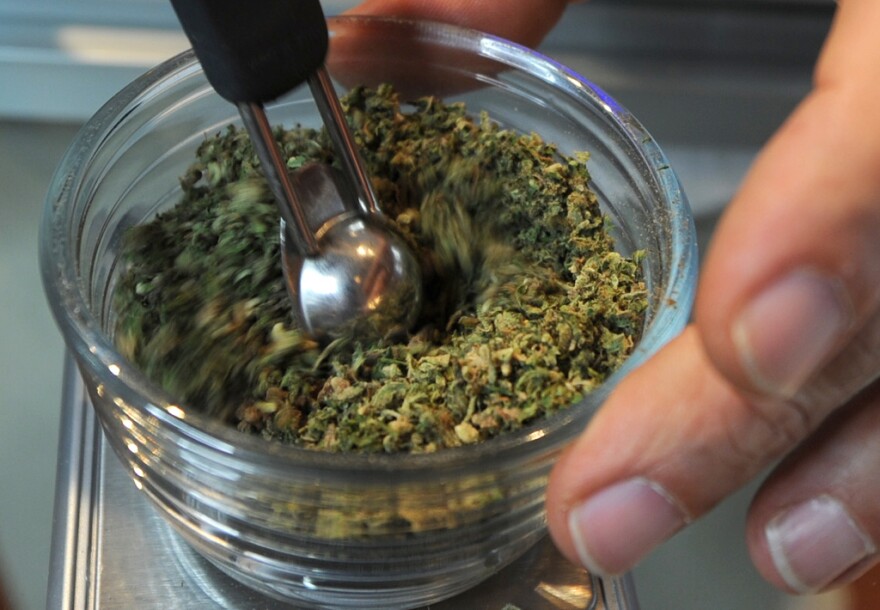 The owner of the Nirvana Pharmacy, a medical marijuana shop in Los Angeles, California, works on his products on March 24, 2010. There are hundreds of medical marijuana shops operating across the city, and a new ordinance from City Hall caps that number at 70, but grants a reprieve to the 187 medical marijuana dispensaries whose operators registered with the city prior to a moratorium. The ordinance requires that dispensaries be at least 1,000 feet away from schools, public parks, public libraries, religious institutions and other so-called ``sensitive use'' sites. 