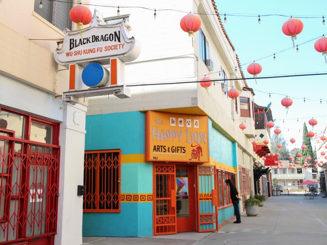 A tourist looks at goods at The Happy Lion Arts and Gifts shop on Chung King Road in Chinatown.