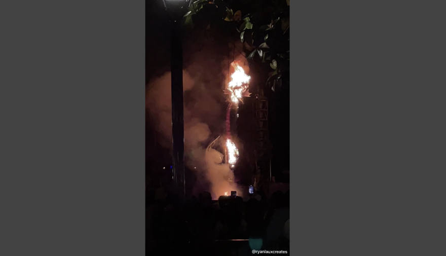 Flames are visible at the top and bottom of a massive animatronic dragon.