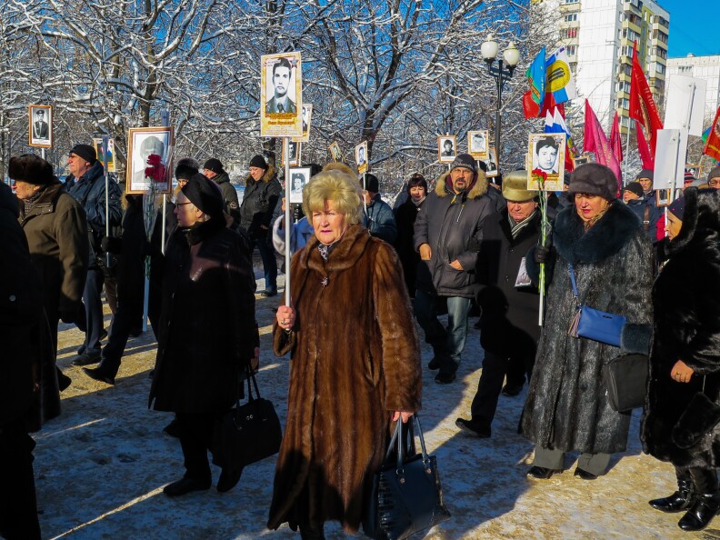 Muscovites carry the portraits of young Soviet soldiers who fell in Afghanistan. The Soviets withdrew from the country 30 years ago.