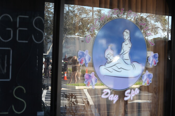 JUPITER, FLORIDA - FEBRUARY 22: People are reflected in the window of the Orchids of Asia Day Spa after New England Patriots owner Robert Kraft is charged with allegedly soliciting for sex on February 22, 2019 in Jupiter, Florida. Mr. Kraft was caught up in a law enforcement operation in South Florida that netted hundreds of johns over the past two weeks.(Photo by Joe Raedle/Getty Images)