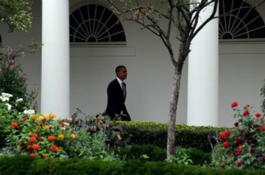 President Barack Obama walks along the colonnade before boarding Marine One.