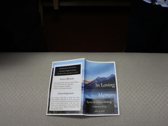 The program for Byron and Gladys McKaig's memorial rests on a bench as attendees stand during the service held at St. Peter's Anglican Church in Kernville, California, July 23, 2016.