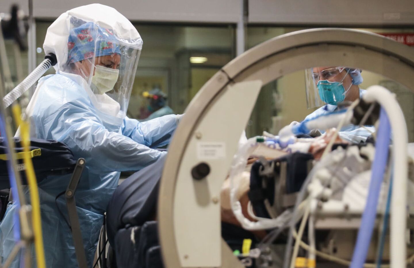 LA MESA, CALIFORNIA - MAY 05: (EDITORIAL USE ONLY) Nurse  Kristyna Saja (L) and nurse Amanda Miller care for a COVID-19 patient in the Intensive Care Unit (ICU) at Sharp Grossmont Hospital amidst the coronavirus pandemic on May 5, 2020 in La Mesa, California. The patient is being treated in a RotoProne bed which rotates the patient to improve ventilation. Sharp HealthCare is the largest health system in San Diego County and is currently treating more than 120 COVID-19 patients at its four hospitals. (Photo by Mario Tama/Getty Images)