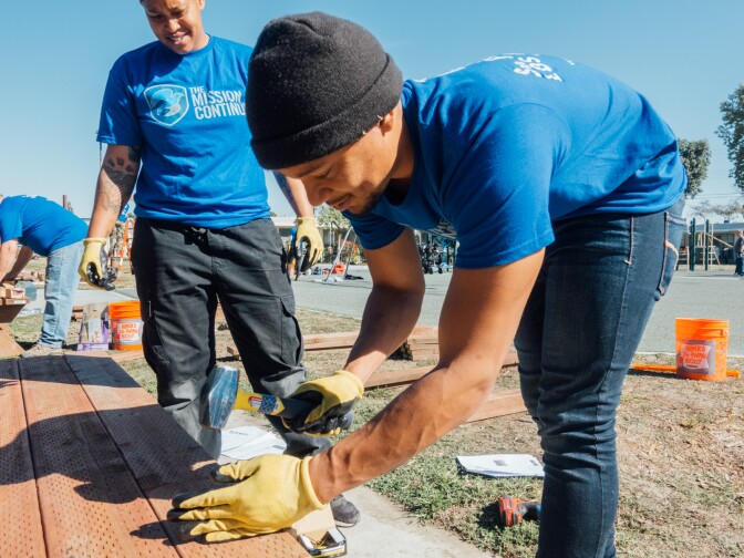 The Mission Continues fellow Stephanie Lewis (left) joins another volunteer constructing a picnic table at Gonzaque Village in Watts.