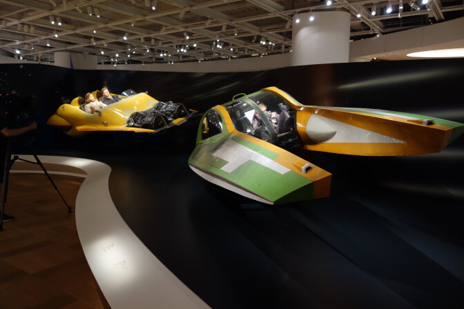 Vehicles from the Star Wars universe set up on a museum display.