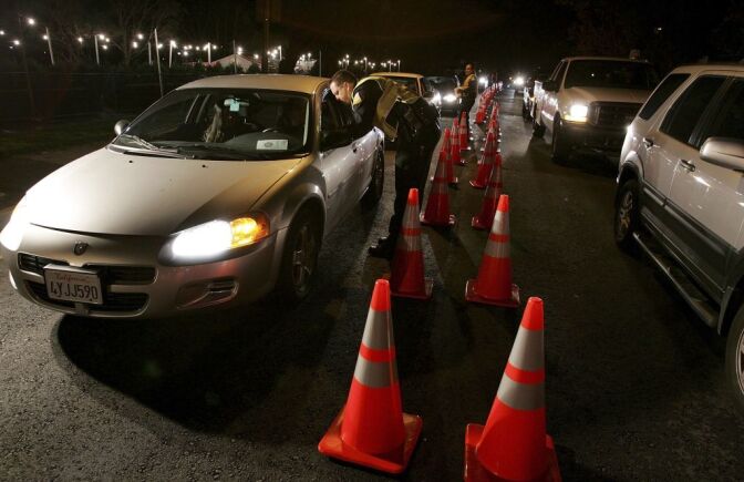 San Bruno police officers stop cars at a DUI checkpoint on Nov. 27, 2006 in San Bruno, California.