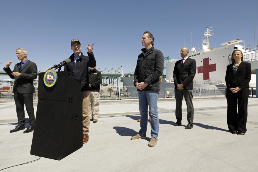 LOS ANGELES, CA - MARCH 27: California Governor Gavin Newsom listens as Los Angeles Mayor Eric Garcetti speaks in front of the hospital ship USNS Mercy that arrived into the Port of Los Angeles on Friday, March 27, 2020, to provide relief for Southland hospitals overwhelmed by the coronavirus pandemic. (Photo by Carolyn Cole-Pool/Getty Images)