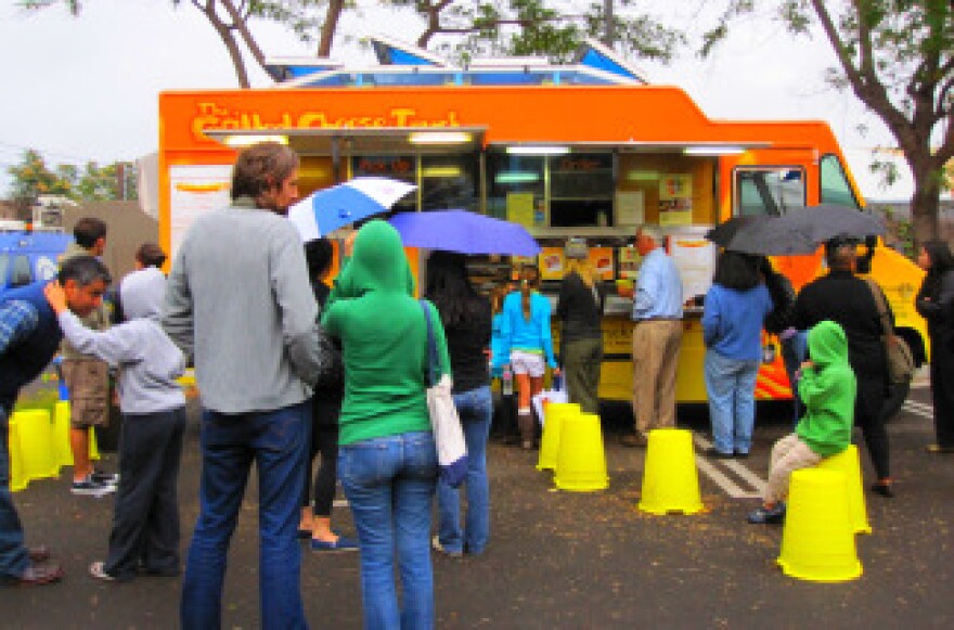 Audience members stand in line for the Grilled Cheese Truck at KPCC's food truck event in the Crawford Family Forum, Tuesday, October 5, 2010.