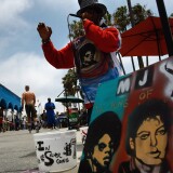 LOS ANGELES, CA - JUNE 28:  A painting of Michael Jackson awaits sale as artist and street performer Tony Conscious sings Michael Jackson hits at Venice Beach on June 28, 2009 in Los Angeles, California. Jackson, 50, the iconic pop star, died after going into cardiac arrest on June 25, 2009 in Los Angeles, California.  (Photo by John Moore/Getty Images) *** Local Caption *** Tony Conscious