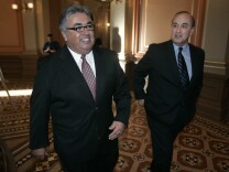 State Sen. Ron Calderon, D-Monterey Park, left, smiles as he walks through the Capitol with his brother, former assemblyman Charles Calderon, D-Whittier, after his early primary measure was approved by the Assembly at the Capitol in Sacramento, Tuesday, March 6, 2007.