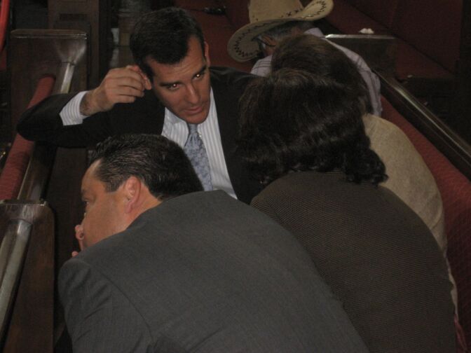 Los Angeles City Council President Eric Garcetti huddles with labor union leaders as the council considers confronts a $400 million budget shortfall. Powerful union leaders are demanding the city enact an early retirement plan.