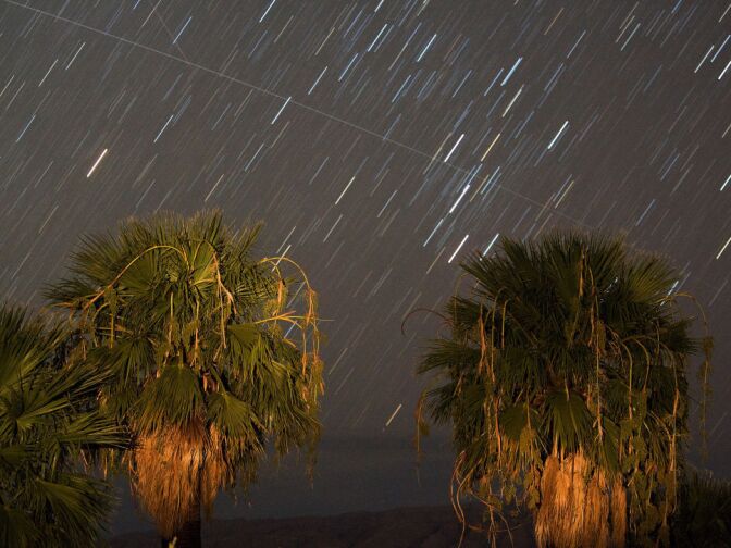 LAKE MEAD NRA, NV - AUGUST 12:  Perseid meteors streak across the sky early August 12, 2008 near Rogers Spring in the Lake Mead National Recreation Area, Nevada. The meteor display, known as the Perseid shower because it appears to radiate from the constellation Perseus in the northeastern sky, is a result of Earth's orbit passing through debris from the comet Swift-Tuttle. Tuesday morning was considered the peak of the shower, which is visible every August.  (Photo by Ethan Miller/Getty Images)