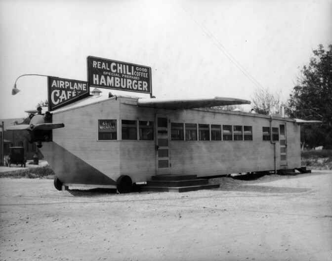 Although the exact L.A. location of The Airplane Café is unknown, the airplane-shaped restaurant came with wings, a propeller and wheels, although it rested on raised slabs of wood. (circa 1924) (Photo via Los Angeles Public Library Collection)