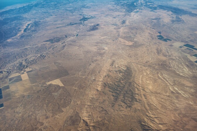 An aerial view of a stretch of the San Andreas Fault north of the Carrizo Plain, east of San Luis Obispo and Paso Robles. The fault runs from top to bottom down the center of the photo.