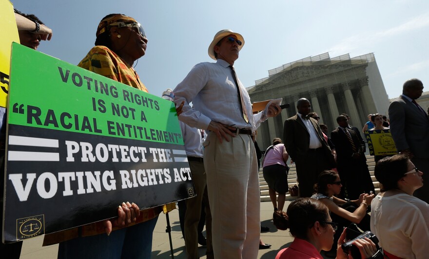 Supporters of the Voting Rights Act listen to speakers discussing today's rulings outside the U.S. Supreme Court building on June 25, 2013 in Washington, DC. The court ruled that Section 4 of the Voting Rights Act, which aimed at protecting minority voters, is unconstitutional. The high court convened again today to rule on some high profile decisions including two on gay marriage and one on voting rights.