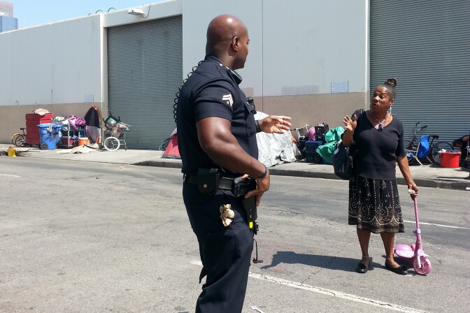 LAPD Officer Deon Joseph talks with one of the women who call Skid Row home.