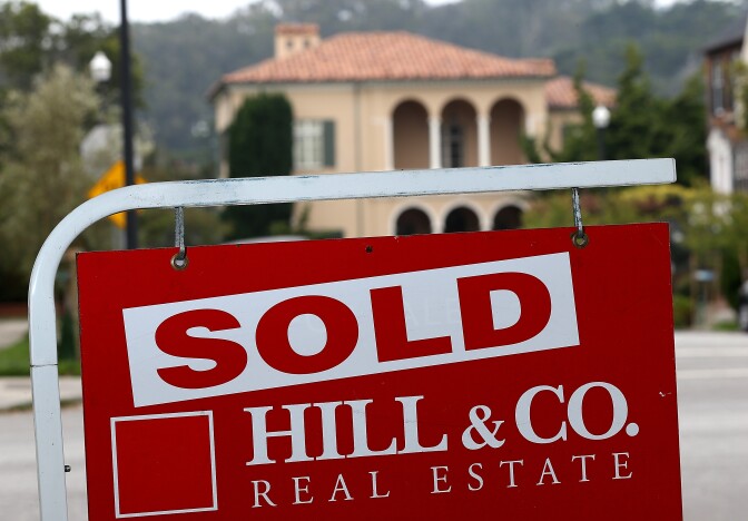  A sold sign is posted in front of a home for sale on July 30, 2013 in San Francisco, California. The report notes that people in California spend more of their income on housing than anywhere else in the country. 