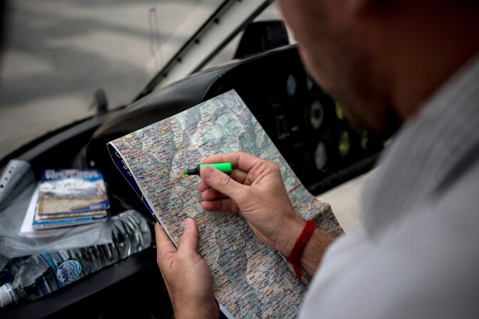 UNSPECIFIED LOCATION, NEPAL - MAY 17:  Doctor Dan Sermand from MSF, finds the location on a map where today's delivery will go on May 17, 2015 in Nepal. The devastating magnitude 7.8 earthquake of April 25 claimed over 8,000 lives. Doctors from all over the world have travelled to Nepal with MSF, Medecins Sans Frontieres, to reach out to earthquake victims in remote village to deliver medicine, expertise and to evacuate wounded.  (Photo by Jonas Gratzer/Getty Images)