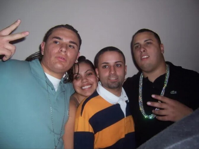 A group of three Latino men and a Latina woman pose for a photo. 