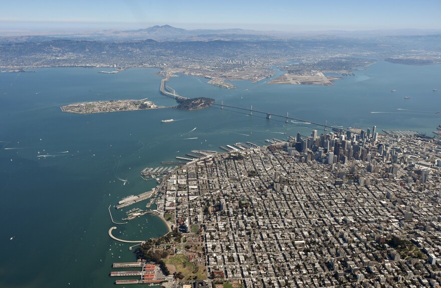 The Bay Bridge and the San Francisco Bay are seen from above in San Francisco, California.