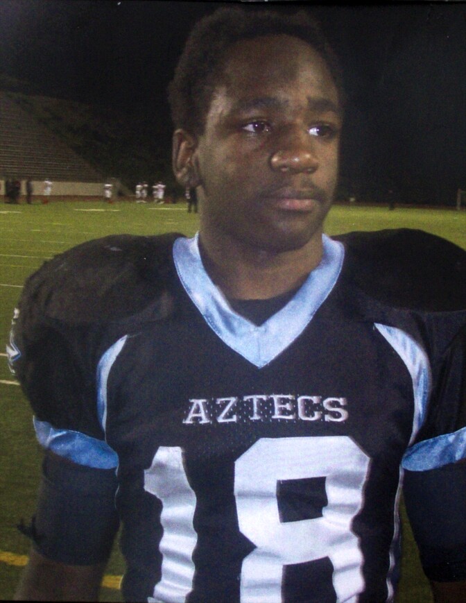 In this undated family photo, Kendrec McDade, then a high school student, is seen wearing his Aztecs Football team uniform. McDade was shot by police after being chased and allegedly reaching into his waistband, according to police.