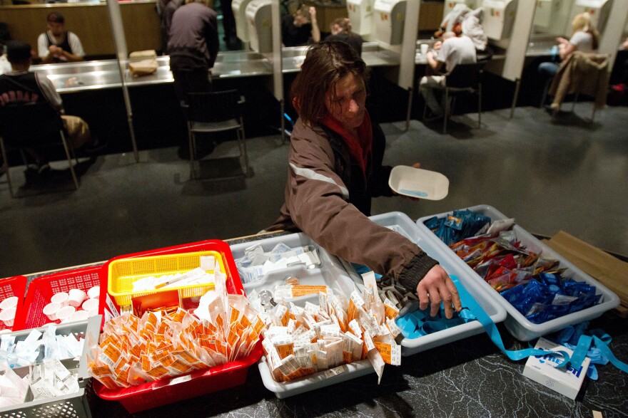 TO GO WITH AFP STORY by Laurent VU THE, Canada-society-drugs-health
A client of the Insite supervised injection Center in Vancouver, Canada, collects her kit on May 3, 2011. The Canadian Supreme Court is to settle a conflict between the government's wishes to close the center and the center's success in fighting the spread of AIDS among drug addicts. In eight years of existence, and with more 600 visits per day on average, Insite believes it has made advances in the fight against AIDS. And in a radius of 500 meters around the center, deaths by overdose dropped by 35 percent since the opening, according to a study published in the medical newspaper The Lancet.    AFP PHOTO/Laurent Vu The (Photo credit should read Laurent Vu The/AFP/Getty Images)