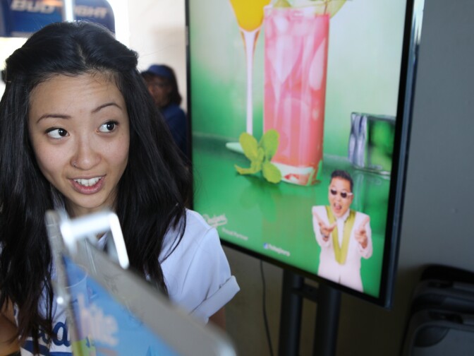 A vendor mixes free sample Soju cocktails in an effort to get more Dodgers fans to buy the Korean adult beverages at the stadium.