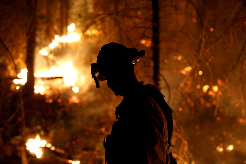 A firefighter from Cosumnes Fire Department monitors a back fire while battling the Rim Fire on August 22, 2013 in Groveland, California.