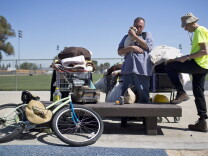 Volunteer Philip Armstrong, right, works with Kenneth Reynolds during a weekly outreach assessment put on by the Coast to Coast Foundation in partnership with the Fullerton Police Department on Thursday, March 5, 2015 at Pacific Drive Park.