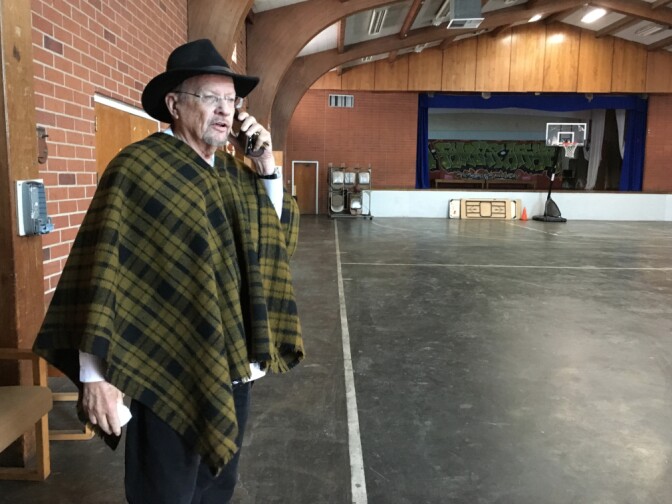 The Rev. Fred Morris takes a call inside the gymnasium of the North Hills United Methodist Church. He said that a couple of rooms on the church campus can be used as an apartment for a family, and that unauthorized immigrants seeking shelter could also sleep in the gymnasium.