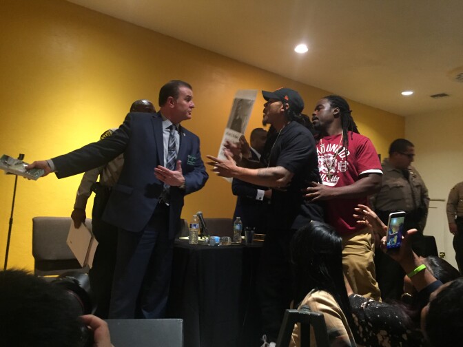 Sheriff’s Captain Chris Bergner (left), who is overseeing the investigation into the killing of 16-year-old Anthony Weber by a deputy, is confronted Wednesday night by the boy’s older brother John Weber during an emergency town hall sponsored by the Sheriff’s Civilian Oversight Commission. 