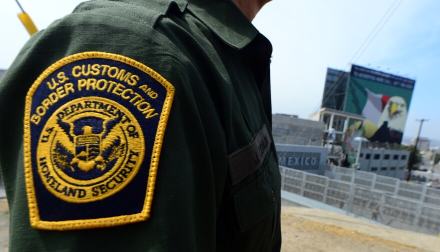 A US Border Patrol agent stands near a crossing to Mexico at the San Ysidro port of entry along the US-Mexico border near San Diego, California on April 4, 2013. The barrier separating the two countries known to many as the 'border fence' or the 'border wall' is in reality several barriers, designed to prevent illegal movement across the border, backed by supporters and criticized by opponents. 