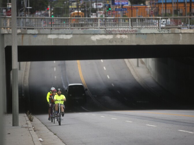 Charles Dandino, KPCC's Meghan McCarty and Tushar Thrivikraman approach North San Fernando Road on Fletcher Drive on Thursday morning, July 9, 2015 during a bike train commute to Jet Propulsion Laboratory.