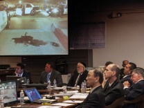 Jurors see an image of a pool blood left after Fullerton police arrested Kelly Thomas in 2011 as officers Manuel Ramos, second from right, and Jay Cicinelli, second from left, listen during opening statements in their trail.