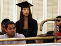 Maria Luna, 23, a 2010 graduate of California State University, Sacramento, sits in the Assembly gallery at the Capitol in Sacramento on May 5, 2011, wearing her graduation cap and gown to show her support for a measure to allow students who are in the country illegally to collect privately funded college scholarships.