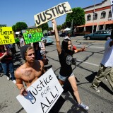 Demonstrators march in 2011 to protest the death of Kelly Thomas, a homeless man who died in July 2011 after an altercation with several Fullerton police officers.  
