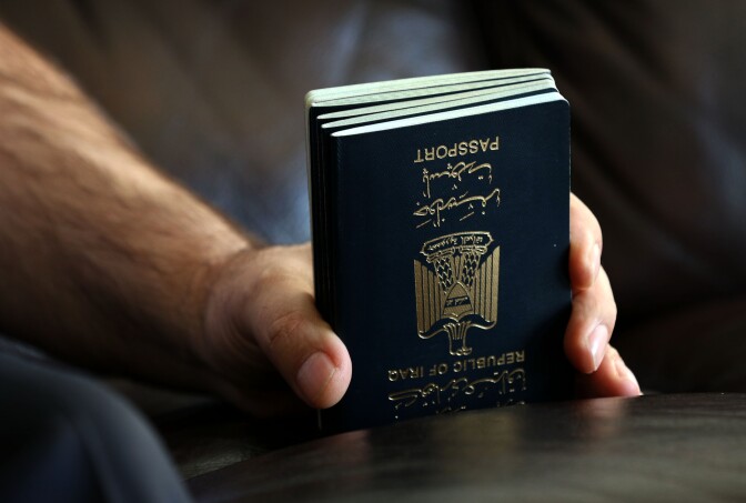 Fuad Sharef Suleman holds the passport of his family members in Arbil, the capital of the Kurdish autonomous region in northern Iraq, on January 30, 2017 after returning to Iraq from Egypt, where him and his family were prevented from boarding a plane to the US following US President Donald Trump's decision to temporarily bar travellers from seven countries, including Iraq.  / AFP / SAFIN HAMED        (Photo credit should read SAFIN HAMED/AFP/Getty Images)