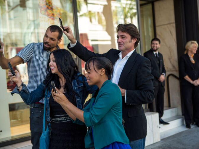 Aspiring actors in Hollywood take photos of a fake celebrity for Adam Swart's Crowds On Demand business. The firm launched in October 2012 and has already had 20 clients.