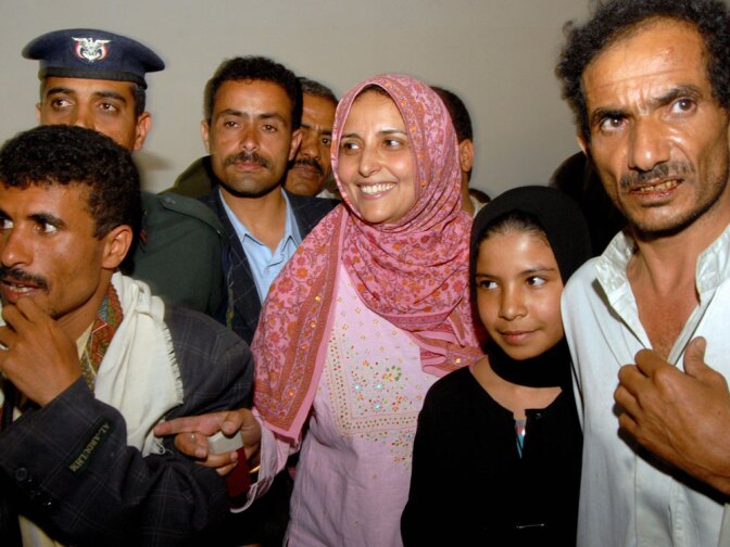 In this April 2008 photo, Ali (second from right), her lawyer, Shada Nasr (third from right), father, Mohammed Ali Al-Ahdal (right) and husband, Faez Ali Thameur (left) attend a public hearing regarding the young girl's arranged marriage and request for divorce at a court in San'a, Yemen.