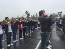 Students spent hours practicing in the rain outside of Dodger Stadium to prepare for the Rose Parade .