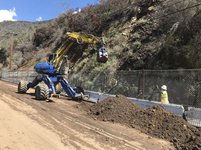 Crews work to clear Topanga Canyon Blvd. after a mudslide in the early hours of Thursday, March 15, 2018.