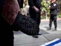 April 17, 2010: A member of the NSM (National Socialist Movement) raises his German-made boot to show the swastika markings on the bottom after stomping on an Israeli Flag. NSM members organize for a rally at a Riverside, Calif. motel in preparation to march on the steps of Los Angeles City Hall in protest of illegal immigration and other party issues.