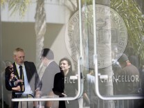 Demonstrators are reflected in windows at the main entrance to the CSU Chancellor's office in Long Beach Wednesday. Students and activists were showing their opposition to a systemwide $280 per semester "Student Success Fee."